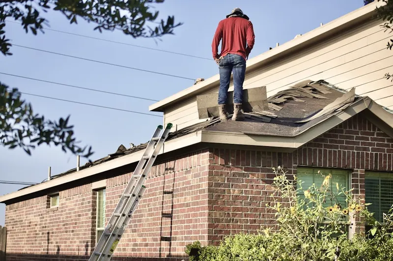 Professional roofer working on a residential roof in Burleys Corner